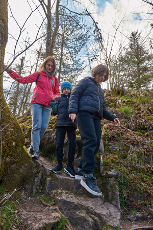 Family hiking in mountains travel adventure vacations group hikers couple with baby trekking outdoor healthy lifestyle eco tourismの写真素材