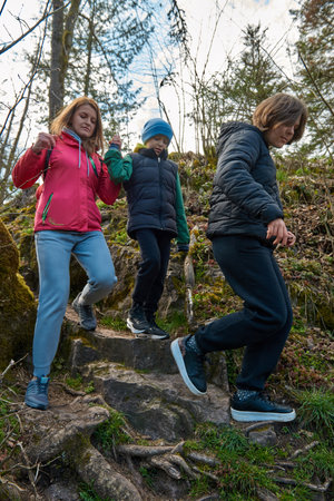 Family hiking in mountains travel adventure vacations group hikers couple with baby trekking outdoor healthy lifestyle eco tourismの写真素材