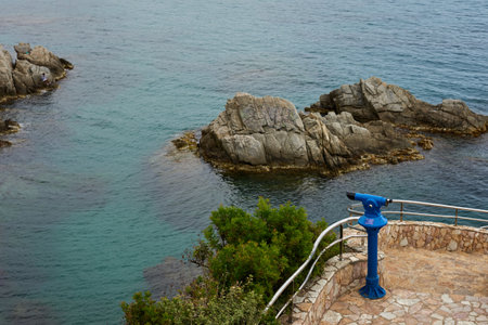 Sea view rocks and tourist telescope. Sea Rocks Telescope Lookout. Stationary binoculars, telescope,...