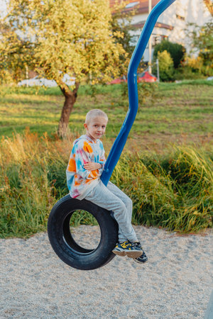 Funny cute happy baby playing on the playground. The emotion of happiness, fun, joy. Smile of a child. boy playing on the playgroundの写真素材