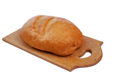 Bread lies on a wooden cutting board on a white background.の写真素材