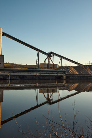 Riverside Manufacturing Hub. Eco-Friendly Technology and Production. industry and the environment, showcasing the integration of sustainable practices.の写真素材