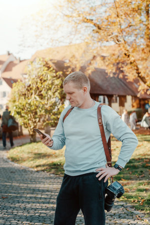 Professional Photographer Taking Picture Of Beautiful Autumn Park. Man Professional Photographer...