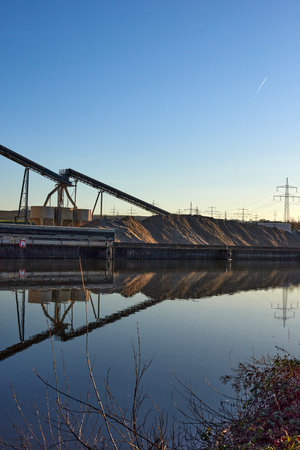 Riverside Manufacturing Hub. Eco-Friendly Technology and Production. industry and the environment, showcasing the integration of sustainable practices.の写真素材