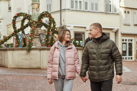 Loving couple of tourists walking around old town. Couple of lovers leisurely stroll in the cool...