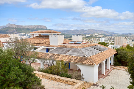 Breathtaking Aerial View Calpe Spain Mediterranean Coastline Penon de Ifach Rock Lush Vegetation Sunny Day Tourism Paradise, Panoramic Vista Calpe Costa Blanca Turquoise Waters Golden Beaches Iconic Rock Formation Flora Foreground Scenic Landscapeの写真素材