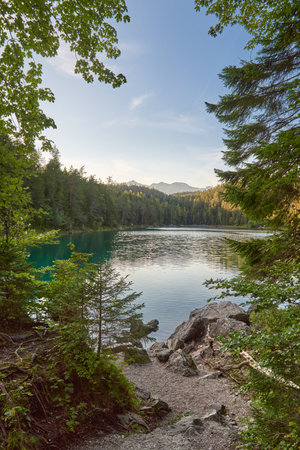 Scenic View of Eibsee Lake with Zugspitze Mountain at Sunset in Bavaria, Germany. Stunning Eibsee...