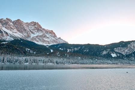 Breathtaking Alpine Winter Wonderland: Majestic Zugspitze Mountain Reflects in Frozen Eibsee Lake...
