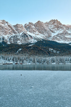 Mesmerizing Twilight Alpine Wonderland: Eibsee Lake Reflects Snow-Capped Zugspitze Mountain Amidst...