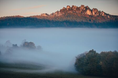 Unusual magic autumn landscape. Mist on the meadow and