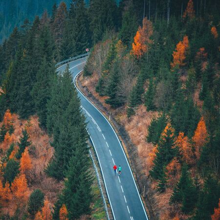 Runner man running on road in autumn banner countryside landscape in cold weather fall season.の写真素材