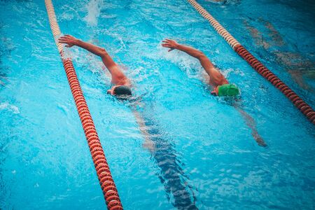 Professional swimming training. Two athlete swim together in the pool.の写真素材