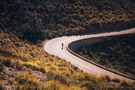 Silhouette of athlete on road bicycle. Edit space Original sport wallpaperの写真素材