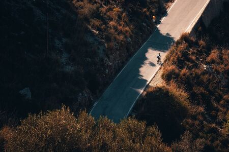 Biker silhouette on the road bicycle ride uphill the famous Sa Calobra climb in Spain.の写真素材