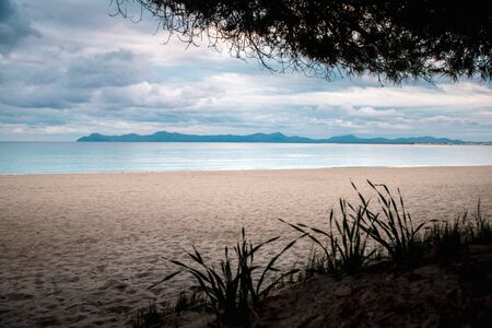 Empty beach in cloudy morning. Melancholy photo.の写真素材