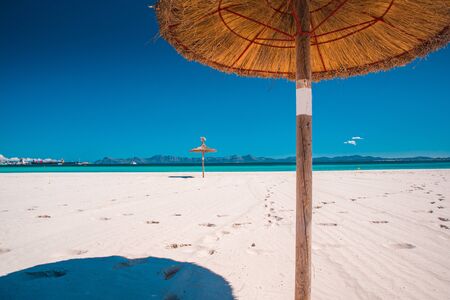 parasol beach on the coast. White sand and blue water of the sea.. Playa de Muro, Mallorca, Majorca, Spainの写真素材