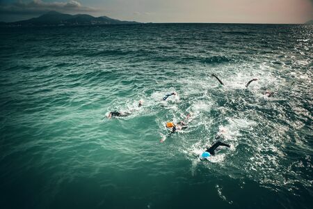 Triathlon swimmers train in open water..の写真素材