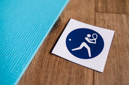 Tennis player pictogram, sport icon, blurred background. Symbol of tennis in summer game Tokyo 2020
