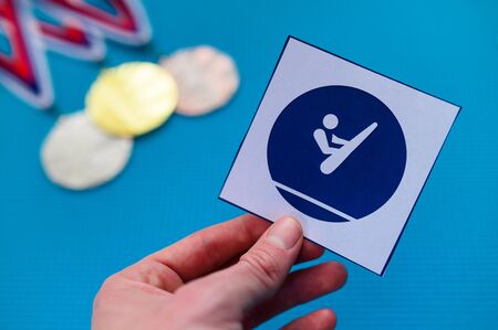 Trampoline Gymnastics icon and medal set, gold silver and bronze medal, blue background.の写真素材