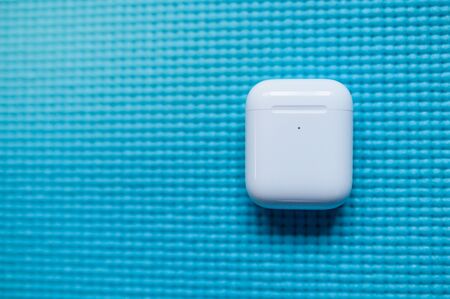 SAN FRANCISCO, USA - FEBRUARY 3, 2020: Apple AirPods Pro white Case, wireless Bluetooth earbuds created by Apple. Blue background.のeditorial素材