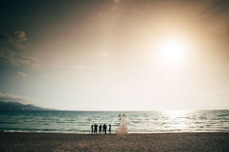 Triathletes prepare for the training in the sea. Sunset sky.. Mallorca, Spainの写真素材