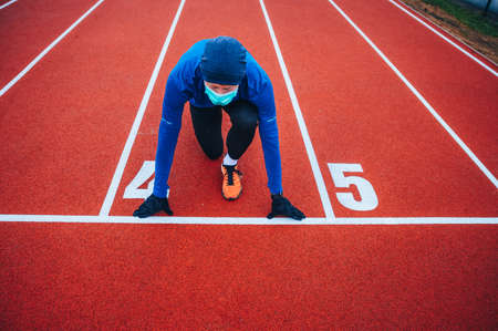Runner wearing medical mask, Coronavirus pandemic Covid-19 in Europe. Sport, Active life in...