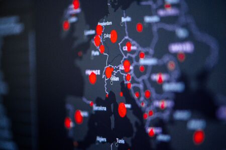 Italy, Rome and Milan. Coronavirus COVID-19 global cases Map. Red Dot showing the number of infected. Johns Hopkins University map on monitor display.の写真素材