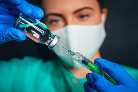 Coronavirus Covid-19 Protection and Vaccine. Syringe, medical injection in hand, palm or fingers....
