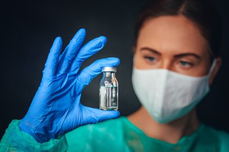 Closeup of a doctor with a bottle of vaccine. Coronavirus Covid-19 Protection and Vaccinationの写真素材