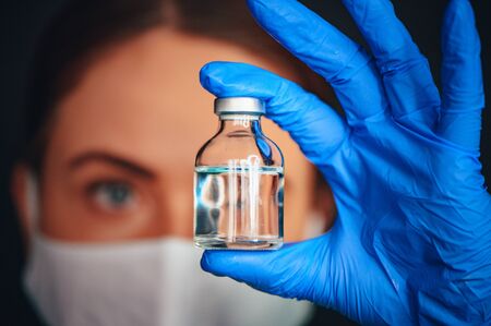 Coronavirus Covid-19 Protection and Vaccine. Medicine bottle for injection medical glass vials and...