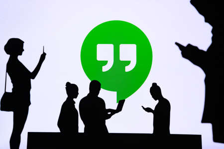 NEW YORK, USA, 25. MAY 2020: Hangout, communication software developed by Google Group of business people chat on mobile phone and laptop. Company logo on screen in backgroundのeditorial素材