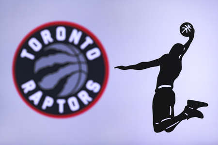 NEW YORK, USA, JUN 18, 2020: Toronto Raptors basketball club logo, silhouette of jumping basket player, sport photo NBA, edit space.のeditorial素材