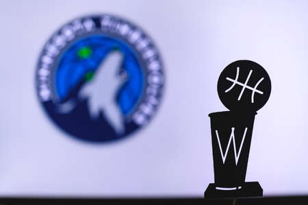 NEW YORK, USA, JUN 18, 2020: Minnesota Timberwolves Basketball club on the white screen. Silhouette of NBA trophy in foreground.のeditorial素材