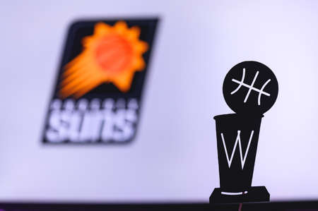 NEW YORK, USA, JUN 18, 2020: Phoenix Suns Basketball club on the white screen. Silhouette of NBA trophy in foreground.のeditorial素材