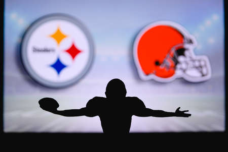 Pittsburgh Steelers vs. Cleveland Browns . NFL Game. American Football League match. Silhouette of professional player celebrate touch down. Screen in background.のeditorial素材