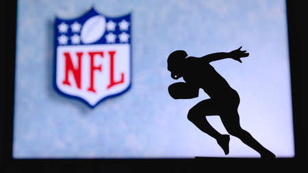 The National Football League NFL. Silhouette of professional american football player. Logo of NFL...