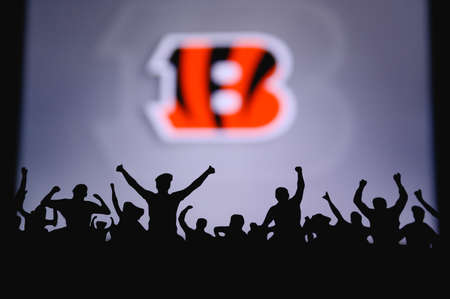 Cincinnati Bengals. Fans support professional team of American National Foorball League. Silhouette of supporters in foreground. Logo on the big screen.のeditorial素材