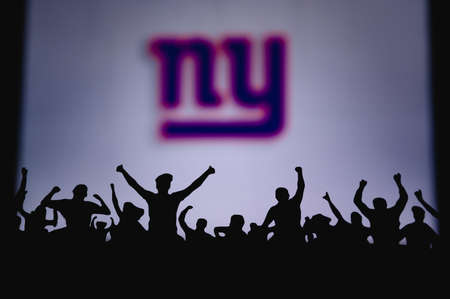 New York Giants. Fans support professional team of American National Foorball League. Silhouette of...