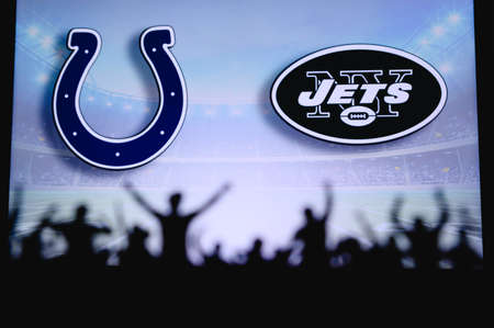 Indianapolis Colts vs. New York Jets. Fans support on NFL Game. Silhouette of supporters, big screen with two rivals in background.のeditorial素材