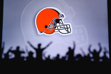Cleveland Browns. Fans support professional team of American National Foorball League. Silhouette of supporters in foreground. Logo on the big screen.のeditorial素材