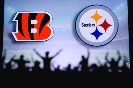 Cincinnati Bengals vs. Pittsburgh Steelers. Fans support on NFL Game. Silhouette of supporters, big screen with two rivals in background.のeditorial素材