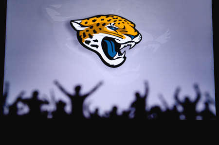 Jacksonville Jaguars. Fans support professional team of American National Foorball League. Silhouette of supporters in foreground. Logo on the big screen.のeditorial素材