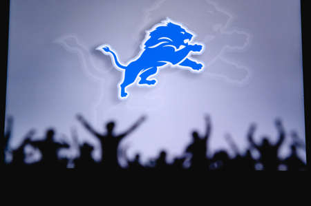 Detroit Lions. Fans support professional team of American National Foorball League. Silhouette of supporters in foreground. Logo on the big screen.のeditorial素材
