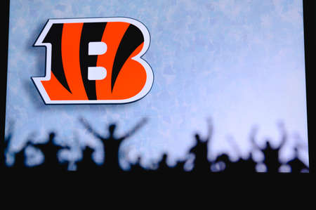 Cincinnati Bengals. Fans support professional team of American National Foorball League. Silhouette of supporters in foreground. Logo on the big screen.のeditorial素材