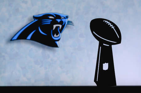 Carolina Panthers professional american football club, silhouette of NFL trophy, logo of the club in background.のeditorial素材