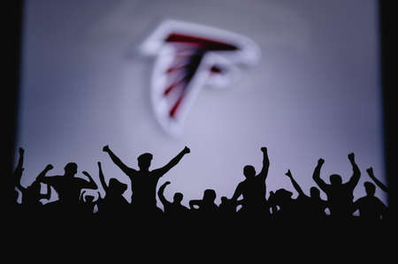 Atlanta Falcons. Fans support professional team of American National Foorball League. Silhouette of supporters in foreground. Logo on the big screen.のeditorial素材