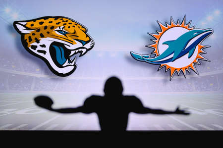 Jacksonville Jaguars Miami Dolphins. NFL Game. American Football League match. Silhouette of professional player celebrate touch down. Screen in background.のeditorial素材