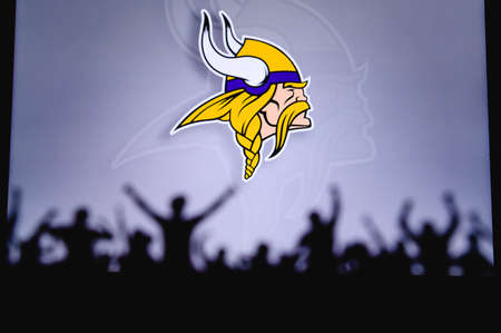 Minnesota Vikings. Fans support professional team of American National Foorball League. Silhouette of supporters in foreground. Logo on the big screen.のeditorial素材