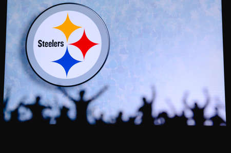 Pittsburgh Steelers. Fans support professional team of American National Foorball League. Silhouette of supporters in foreground. Logo on the big screen.のeditorial素材