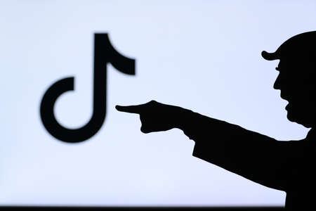 NEW YORK, USA, SEPTEMBER 25, 2020: Donald Trump versus Tik Tok. Silhouette of American President in...